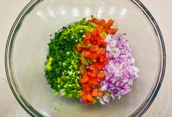 Cut guacamole ingredients in a mixing bowl